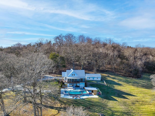 birds eye view of property featuring a view of trees