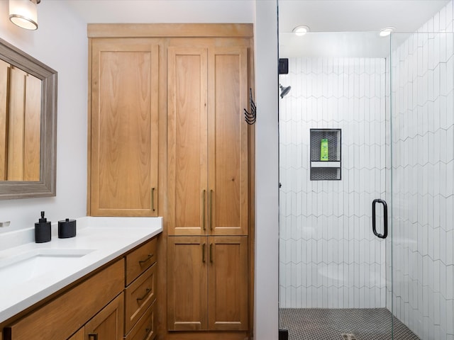 full bath with a shower stall and vanity