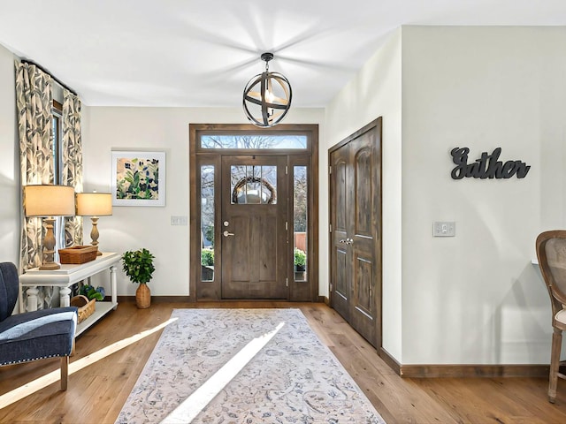 entrance foyer featuring baseboards and wood finished floors