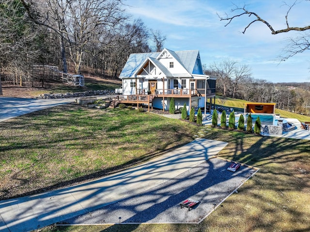 exterior space featuring a deck and a front lawn