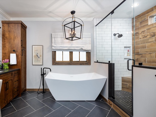 bathroom with tile patterned floors, crown molding, a freestanding tub, a shower stall, and a notable chandelier