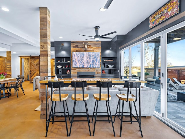 kitchen with finished concrete flooring, ornate columns, ceiling fan, and recessed lighting