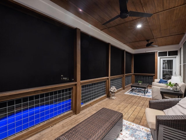 wooden terrace featuring an outdoor hangout area, a sunroom, and a ceiling fan