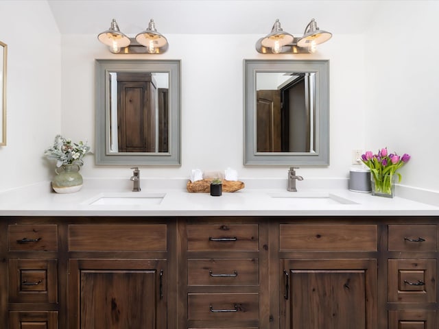 bathroom with a sink and double vanity