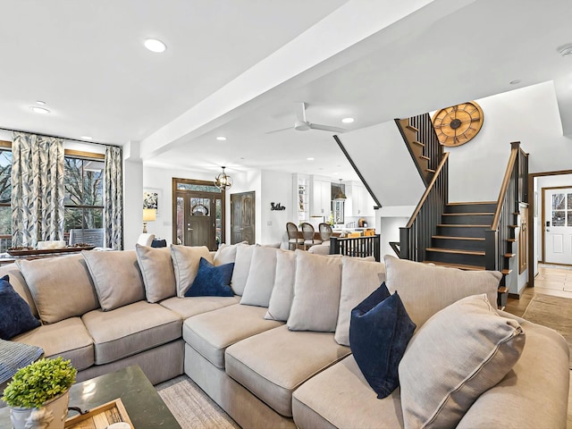 living area with ceiling fan, stairs, and recessed lighting