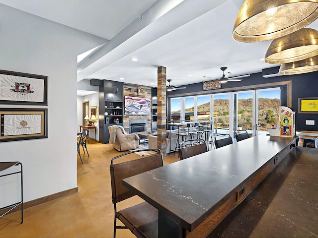 dining area with a large fireplace, baseboards, built in features, and recessed lighting