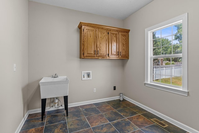 laundry area featuring washer hookup, plenty of natural light, visible vents, and baseboards