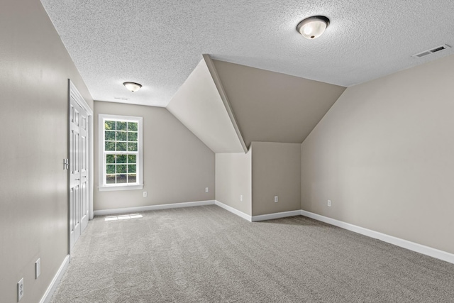 additional living space with vaulted ceiling, carpet, and baseboards