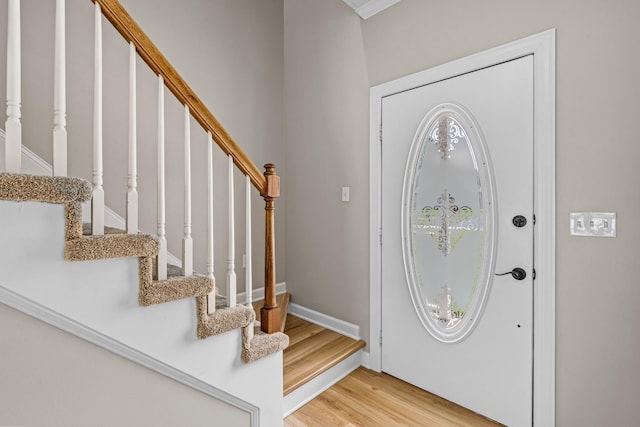 foyer featuring light wood-style flooring and baseboards