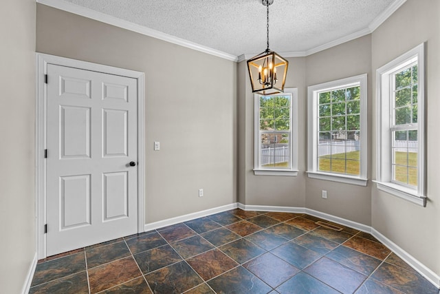 unfurnished dining area featuring an inviting chandelier, a textured ceiling, baseboards, and crown molding