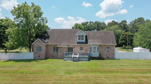 back of house with crawl space, a lawn, and a deck