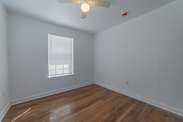 spare room featuring ceiling fan, wood finished floors, and baseboards