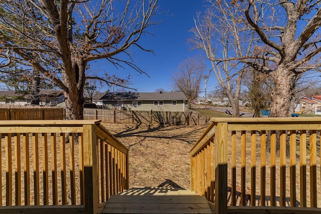 deck with a residential view and a fenced backyard