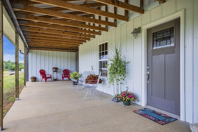 view of exterior entry featuring covered porch