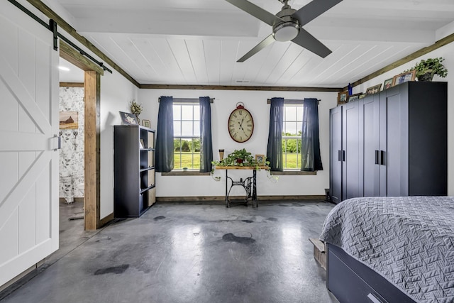 bedroom featuring a barn door, concrete floors, baseboards, and multiple windows