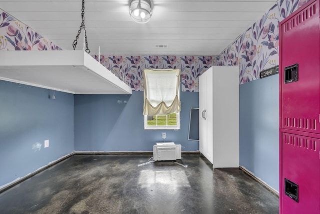 interior space with concrete flooring, visible vents, and wallpapered walls