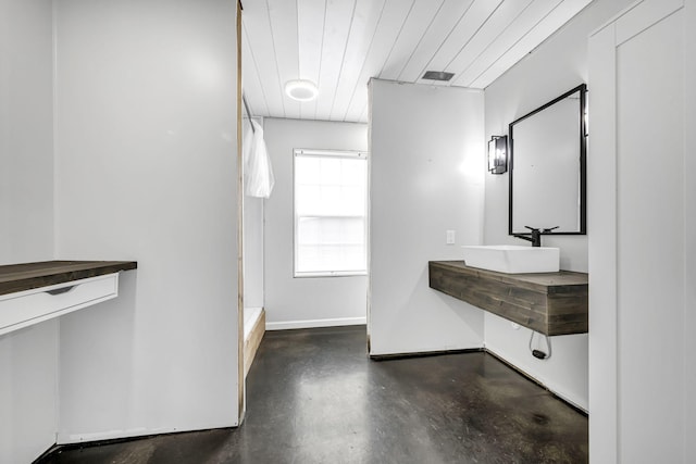 bathroom with visible vents, baseboards, vanity, wood ceiling, and finished concrete floors