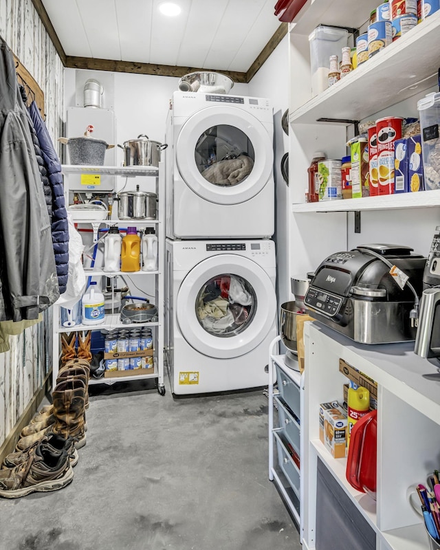 laundry area featuring stacked washer and dryer and laundry area