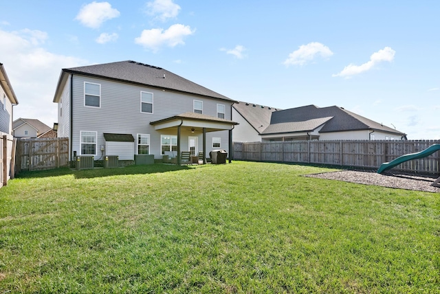 back of house with a lawn, cooling unit, and a fenced backyard