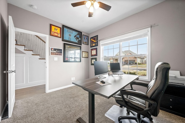 office featuring carpet flooring, ceiling fan, and baseboards