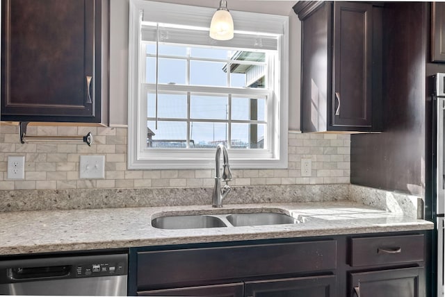 kitchen with dishwasher, a sink, and dark brown cabinetry