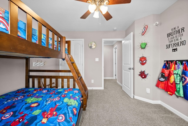 carpeted bedroom with baseboards and a ceiling fan