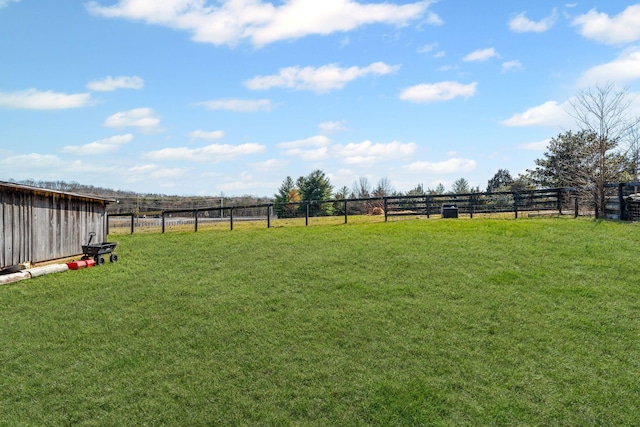 view of yard with a rural view and fence