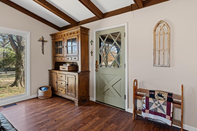 foyer entrance with lofted ceiling with beams, dark wood-style flooring, visible vents, and baseboards