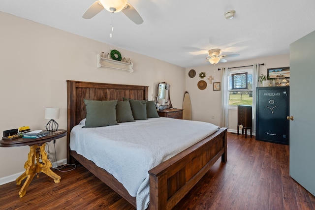 bedroom featuring baseboards, dark wood finished floors, and a ceiling fan