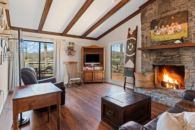 living room featuring vaulted ceiling with beams, a fireplace, baseboards, and wood finished floors