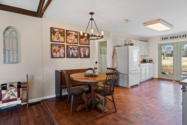 dining area with a notable chandelier and baseboards