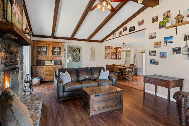 living area featuring ceiling fan with notable chandelier, dark wood-style flooring, and beamed ceiling