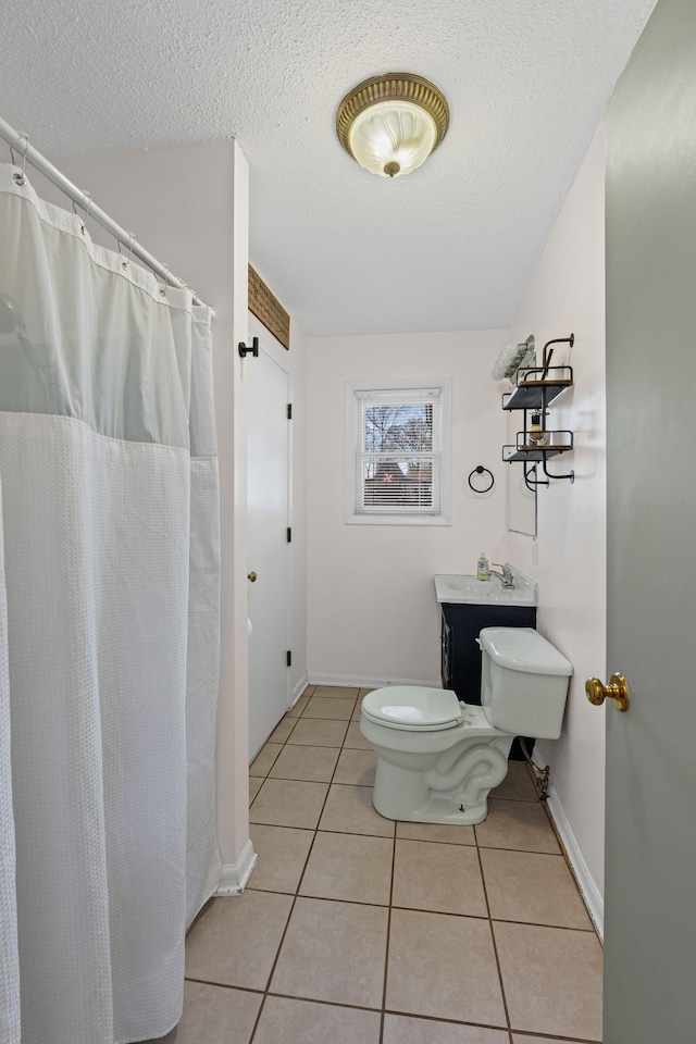 bathroom featuring toilet, a textured ceiling, and tile patterned floors