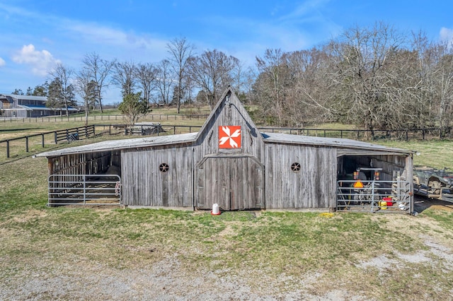 view of outbuilding with an outdoor structure, an exterior structure, and fence