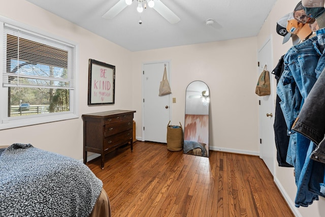 bedroom featuring ceiling fan, wood finished floors, and baseboards