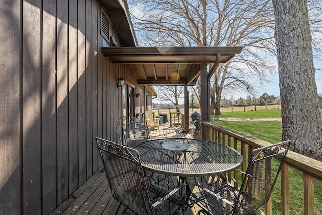 wooden terrace featuring a yard