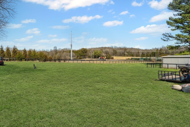 view of yard featuring a rural view and fence