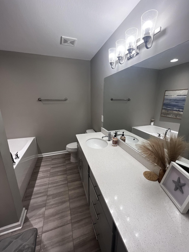 full bathroom with visible vents, toilet, vanity, baseboards, and a bath