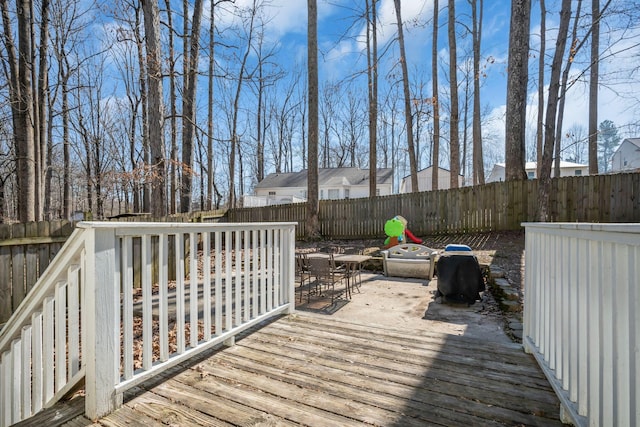 wooden terrace featuring a fenced backyard