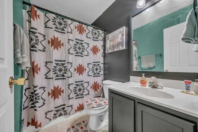 bathroom with vanity, curtained shower, tile patterned flooring, and toilet