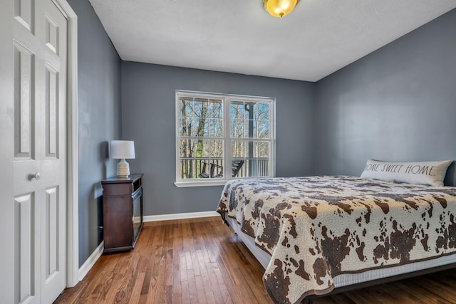 bedroom featuring hardwood / wood-style floors and baseboards