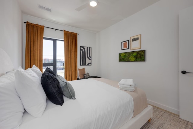 bedroom with baseboards, visible vents, and a ceiling fan