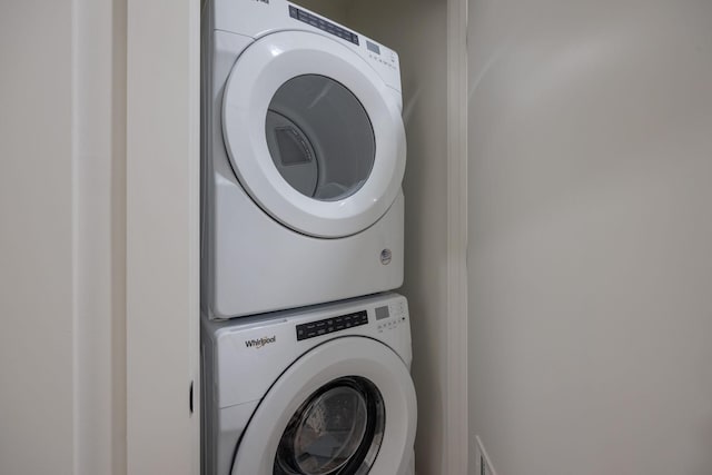 washroom featuring laundry area and stacked washer and clothes dryer