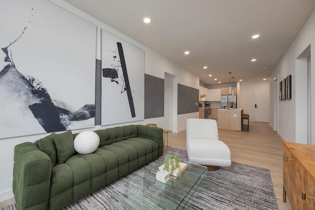 living area featuring light wood-type flooring and recessed lighting