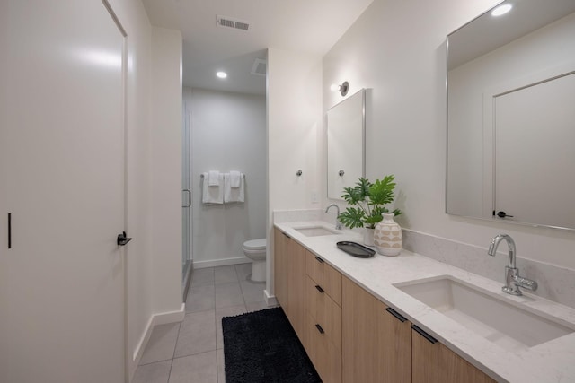 full bathroom featuring toilet, tile patterned flooring, a sink, and visible vents