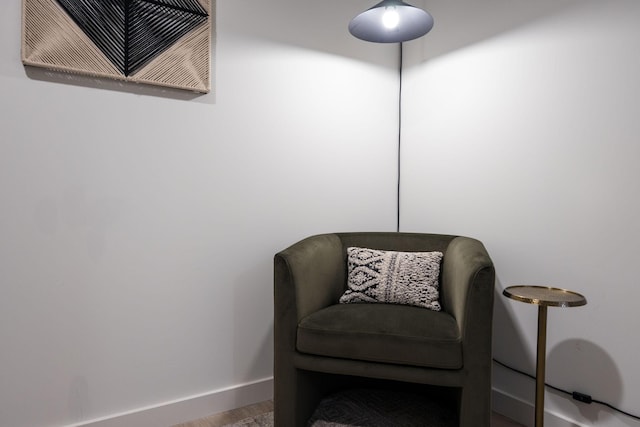 living area featuring visible vents, baseboards, and wood finished floors