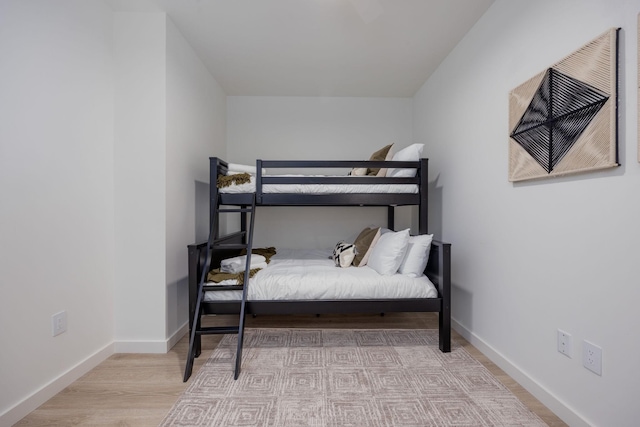 bedroom with baseboards and wood finished floors