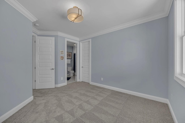 unfurnished bedroom featuring carpet floors, a closet, baseboards, and crown molding