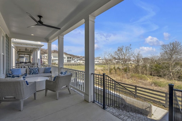 view of patio featuring ceiling fan, a residential view, and fence