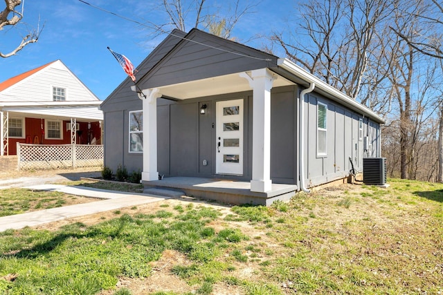 view of front of home with covered porch, central AC unit, and board and batten siding